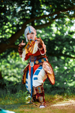Cosplayer in detailreicher Kostümierung, inspiriert von Fantasy-Elementen, posiert auf dem Elbenwald Festival. Die lebendigen Farben und das kreative Design heben die Leidenschaft der Teilnehmer für Musik und Nerd-Kultur hervor.